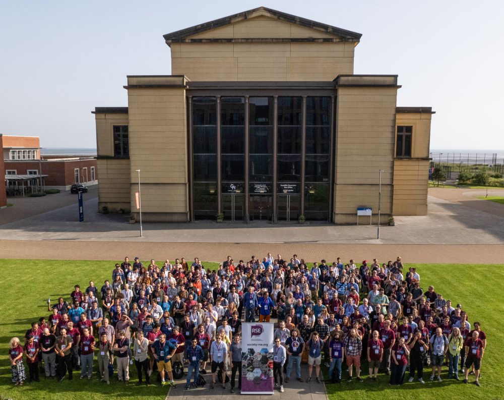 A large group of people standing in front of a building